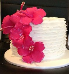 a white cake with pink flowers on top