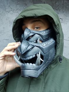 "Cyberpunk style \"ARASAKA\" face mask. The mask has the logo and name of the \"Arasaka\" company, a fictional corporation from the game. Material : Polyurethyane plastic Сlamping: 2 adjustable straps Inside glued lining. Suitable for head sizes of 56-61cm The mask is molded from polyurethane plastic (not 3D printed) The top of the mask is covered with matt varnish. Information & Deadlines I regularly renew the production time according to the current load. If there is an opportunity to produce Cyberpunk Full Face Mask For Protection, Black Post-apocalyptic Mask For Cosplay, Black Post-apocalyptic Style Mask For Cosplay, Post-apocalyptic Full Face Black Mask, Futuristic Black Masks For Cosplay Events, Black Futuristic Masks For Cosplay Events, Cyberpunk Masks For Halloween Protection, Futuristic Full Face Mask For Streetwear, Cyberpunk Halloween Masks For Protection