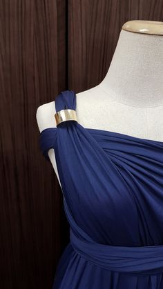 a dress on a mannequin with a gold belt around the waist and shoulders