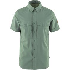 When hikes call for something a little more dialed than a T-shirt but the weather is still warm we button up the Fjallraven Abisko Trekking Short-Sleeve Shirt. This shirt vents well and pulls moisture off of our skin so that we can stay focused on navigation. Green Shirt With Pockets For Outdoor Activities, Outdoor Camp Shirt With Short Sleeves, Short Sleeve Camp Shirt With Button Closure For Outdoor, Outdoor Camp Shirt With Button Closure And Short Sleeves, Functional Short Sleeve Shirt For Outdoor, Green Short Sleeve Shirt For Outdoor Activities, Outdoor Short Sleeve Tops With Button Closure, Short Sleeve Tops With Button Closure For Outdoor, Casual Hiking Shirt With Pockets