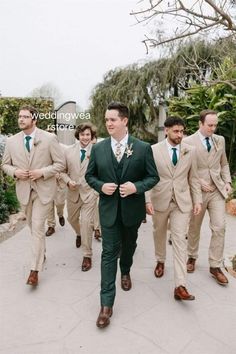 a group of men in suits walking down a sidewalk