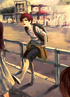 a boy is sitting on a railing and looking at another person walking down the street