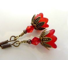 "BRIDESMAIDS EARRINGS red earrings flower vintage style red bell flower wedding bridal jewelry Beautiful bridesmaids earrings, gorgeous petite red bell flower vintage style earrings are available. Hanging from vintage style brass fish hooks, these lovely petite red bell flowers are encased by sweet vintage brass leaf bead caps, finished with red crystal bicone beads. This listing is for 1 pair, but you can buy more for the beautiful bridesmaids. These earrings measure a little more than 1 1/4\" Red Flower Drop Earrings For Wedding, Red Flower Earrings For Wedding, Red Drop Earrings With Flower Charm, Red Flower Shaped Wedding Earrings, Red Flower-shaped Wedding Earrings, Elegant Handmade Red Flower Earrings, Elegant Red Handmade Flower Earrings, Vintage Red Flower Shaped Jewelry, Vintage Red Flower Earrings For Gift