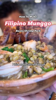 a person holding a bowl of food with meats and beans in it, while the text reads how to make filipino munggo bean shrimp pork