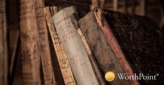 old books stacked on top of each other in front of a wooden wall with the words worthpoint written above them