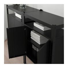 a black cabinet with two doors and some papers