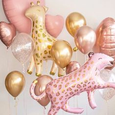 a giraffe balloon is suspended from the ceiling with balloons attached to it's sides