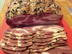 sliced meat sitting on top of a red cutting board