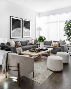 a living room filled with furniture and large windows