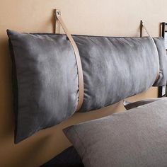 three pillows are hanging on the wall next to each other