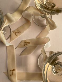 some wine glasses and ribbon on a table