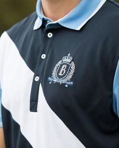 a man wearing a black and white polo shirt with the letter b on it's chest