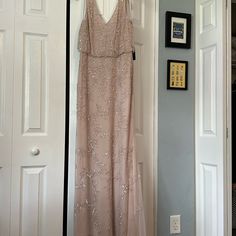 a dress hanging up on a door way