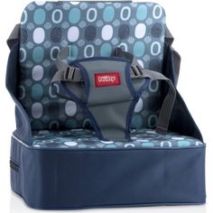 a blue and gray baby seat with polka dots on the back, in front of a white background