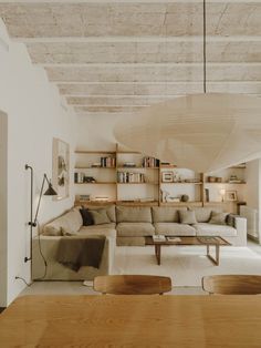 a living room filled with furniture and bookshelves