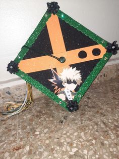 a decorated graduation cap sitting on top of a floor next to a wall and wires