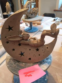 a wooden moon with stars on it sitting on top of a table