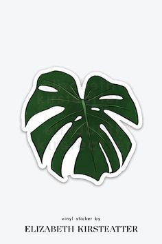 a green leaf sticker with the words, vinyl sticker by elizabeth kirsteater