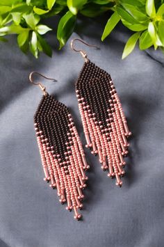 Modern handwoven with gorgeous rose pink and matte jet black quality glass seed beads and strong nylon beading thread. Lightweight, delicate statement earrings. These modern beadwork earrings will add some fun and sparkle to every day wear and can easily be dressed up that fits your style and perfect for any occasions and festivals.  Fringe earrings size Approximate full length of earrings with ear wire: 4.5 inches  IMPORTANT NOTE: - Colors may vary from photos due to lighting and monitor settings - Keeping Shape: Due to woven nature earrings may curl while wearing, simply flatten/reshape with fingers. CARE INSTRUCTIONS: To extend the life of woven beaded jewelry; store away from direct sunlight. High humidity, heat or sun, they can affect beads and cause thread to become brittle. Do not e Seed Bead Brick Stitch, Bead Brick Stitch, Beadwork Earrings, Beading Thread, Nature Earrings, Beaded Crafts