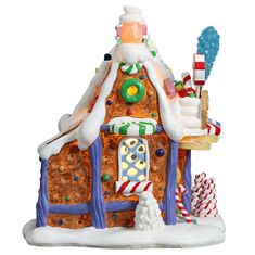 a gingerbread house is decorated with candy canes and candies for the holiday season