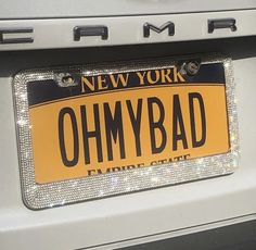 a new york license plate with the word ohmy bad on it's side