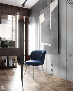 a blue chair sitting in front of a painting on the wall next to a desk