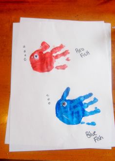 two handprints on paper with blue fish and red fish