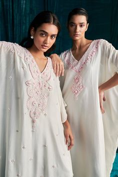 Ivory mul silk kaftan with geometric pattern yoke, contrast pink thread, sequin and cut dana embroidery. - Aza Fashions White Bollywood Kaftan With Traditional Drape, White Intricately Embroidered Festive Kaftan, Festive White Intricately Embroidered Kaftan, Festive White Bollywood Kaftan, White Bollywood Kaftan For Festive Occasions, Festive White Kaftan For Eid, White Dresses With Mirror Work, White Silk Embroidered Kaftan, White Embroidered Silk Kaftan