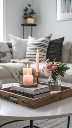 a coffee table with two candles on it