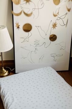 a bed with a white sheet and gold decorations on it