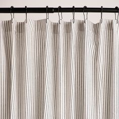 a striped curtain hanging from a metal rod