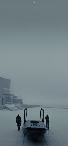 two men walking towards a boat in the snow