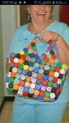 a woman holding a purse made out of bottle caps