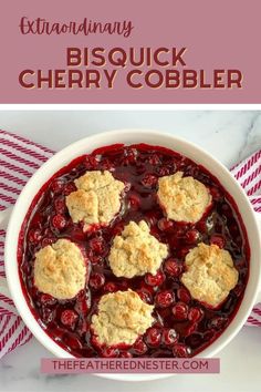 a bowl filled with cranberry cobbler next to a red and white striped napkin