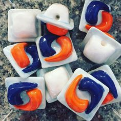 several pieces of art glass sitting on top of a marble counter next to each other