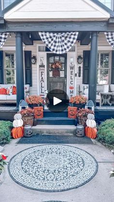 the front porch is decorated for halloween with pumpkins