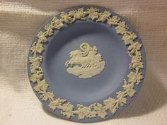 a blue and white plate with an image of a horse on the center is shown