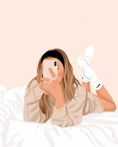 a woman laying in bed while looking at her cell phone and holding it up to her face