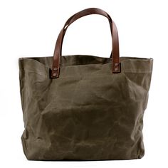 a brown canvas bag with leather handles