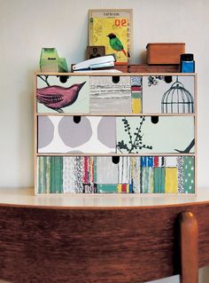 a wooden table topped with drawers filled with books