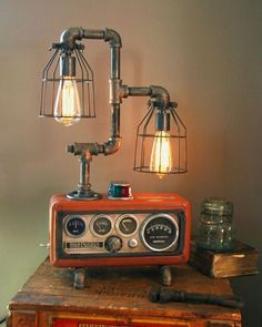 an old fashioned radio sitting on top of a wooden table next to two light bulbs