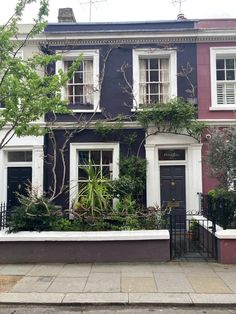 a black and red house with white windows