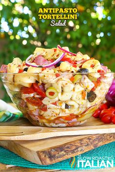 pasta salad in a glass bowl on a cutting board