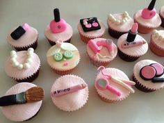 cupcakes decorated with pink icing and various types of beauty products on them