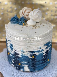 a blue and white cake with gold sprinkles