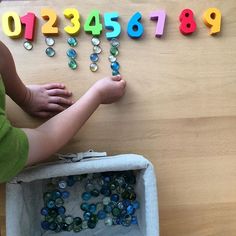 a child is playing with numbers and beads