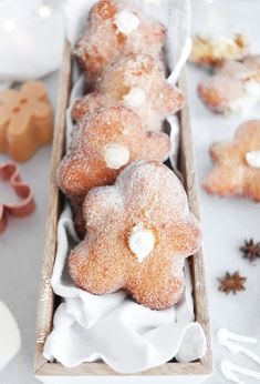 some sugared cookies in a wooden box with icing on them and other decorations