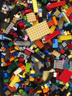 a pile of assorted legos sitting on top of a black table next to each other