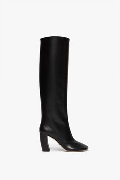 This Rise boot is a tall, pull-on version with a soft, curved 'banana' heel and exaggerated round toe. In smooth black calf leather with a 115mm heel, it's an elegant take on the style. Victoria Beckham Capri Rise Boot 115mm in Black  - Size 36 UK Luxury Round Toe Chelsea Boots With Rubber Heel Cap, Victoria Beckham Shoes, Style Victoria Beckham, Victoria Beckham Collection, Leather Care, Designer Outfits Woman, Victoria Beckham, New Shoes, Calf Leather