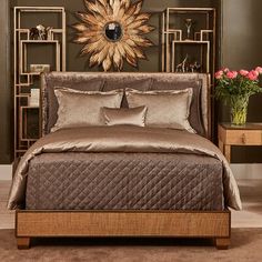 a bedroom with a bed, nightstands and pictures on the wall above it in brown tones